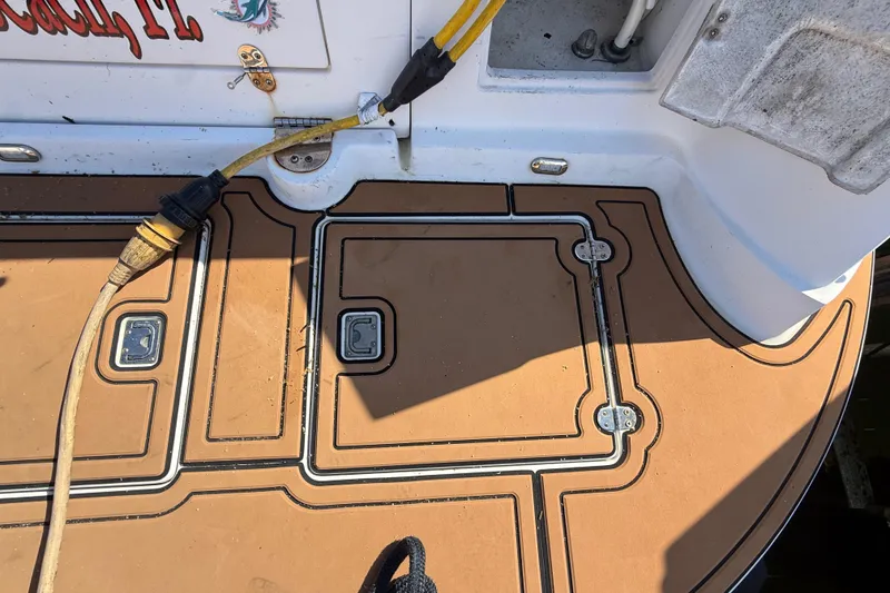 Slide: The Image of 2005 Four Winns 348 Vista boat deck with power cable and storage compartments. - 15