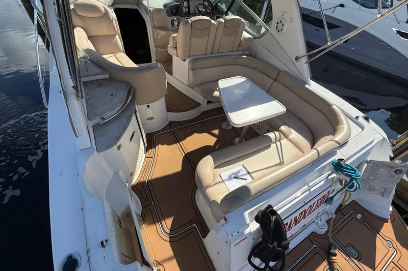 Slide: The Image of 2005 Four Winns 348 Vista boat interior with beige seating and table. - 18