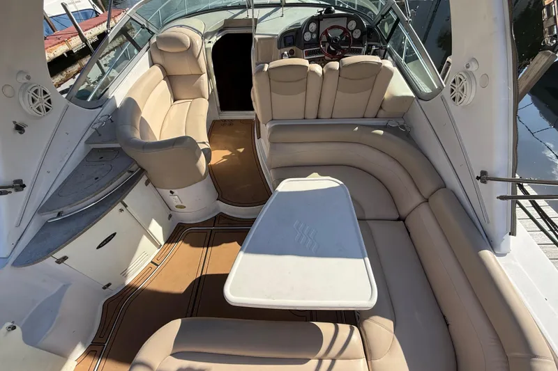 Slide: The Image of 2005 Four Winns 348 Vista boat interior with beige seating and a central table. - 22