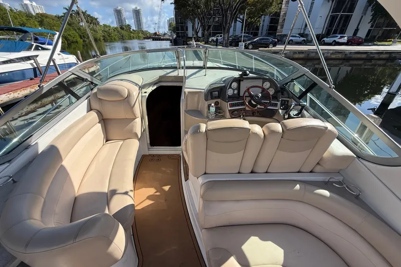 Slide: The Image of 2005 Four Winns 348 Vista boat interior with beige seating and control panel. - 29