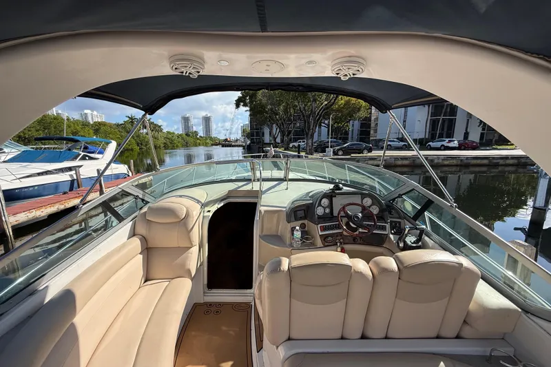 Slide: The Image of 2005 Four Winns 348 Vista boat interior with helm, seating, and waterfront view. - 30