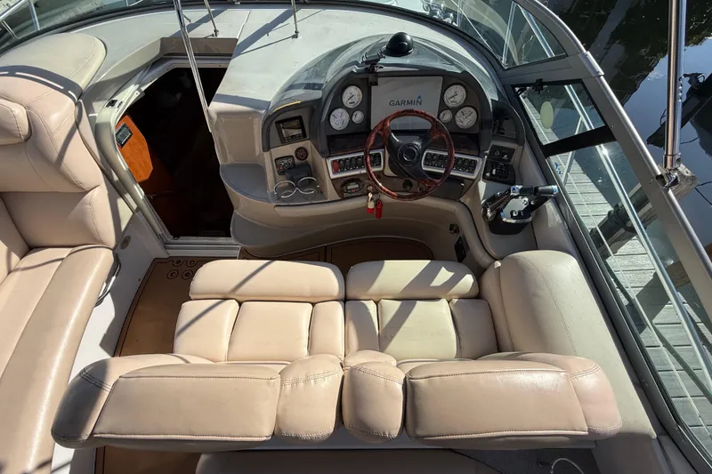 Slide: The Image of 2005 Four Winns 348 Vista boat cockpit with leather seating and control panel. - 31
