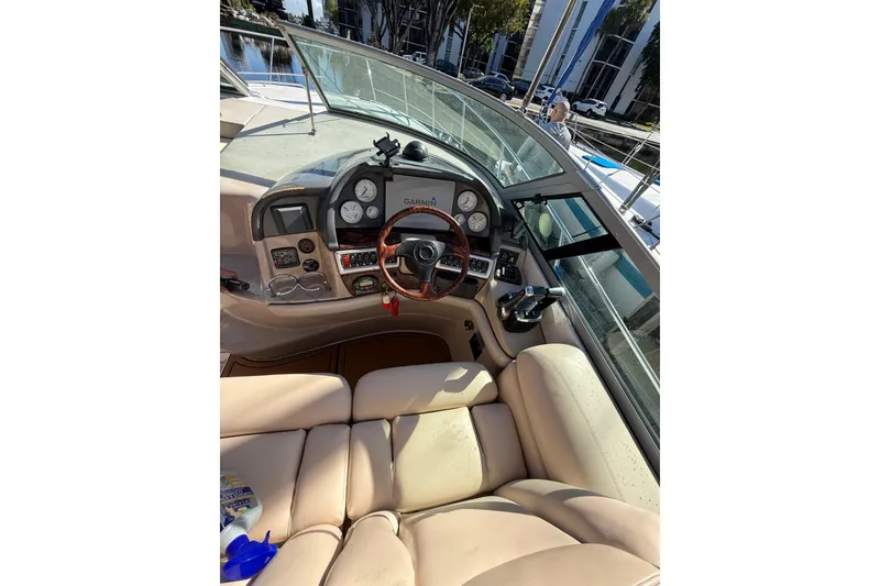 Slide: The Image of 2005 Four Winns 348 Vista yacht docked at a marina with palm trees and buildings. - 4