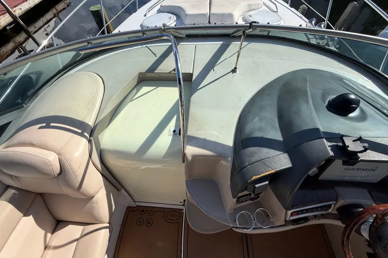 Slide: The Image of 2005 Four Winns 348 Vista boat cockpit with Garmin navigation system and beige seating. - 40