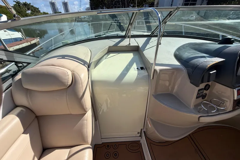Slide: The Image of 2005 Four Winns 348 Vista boat interior with beige seating and control panel. - 42