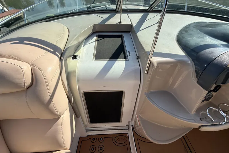 Slide: The Image of 2005 Four Winns 348 Vista boat interior with beige seating and control panel. - 43