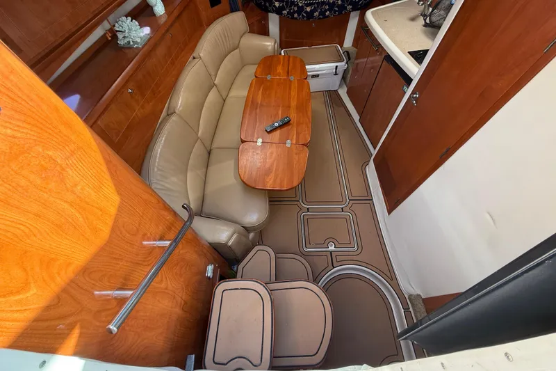 Slide: The Image of Interior of 2005 Four Winns 348 Vista yacht with leather seating and wooden table. - 46