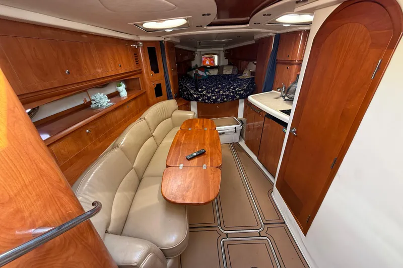 Slide: The Image of Interior of 2005 Four Winns 348 Vista yacht with wood cabinetry and cozy seating area. - 47