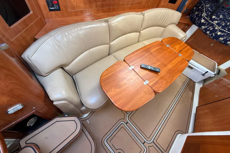 Slide: The Image of Luxurious interior of 2005 Four Winns 348 Vista with leather seating and wooden table. - 49