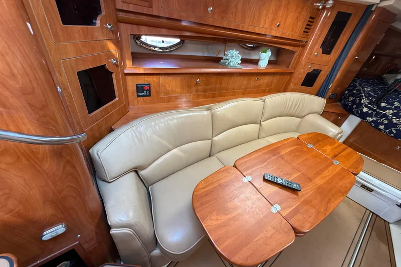 Slide: The Image of 2005 Four Winns 348 Vista interior with leather seating, wooden table, and elegant cabinetry. - 50