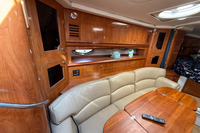 Slide: The Image of Luxurious 2005 Four Winns 348 Vista yacht interior with wood finish and leather seating. - 51