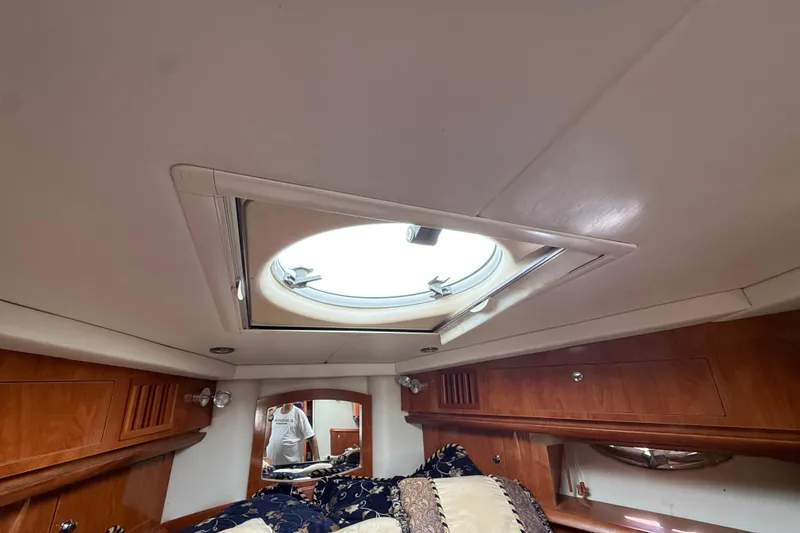 Slide: The Image of Interior cabin of 2005 Four Winns 348 Vista yacht with skylight and wooden cabinetry. - 55