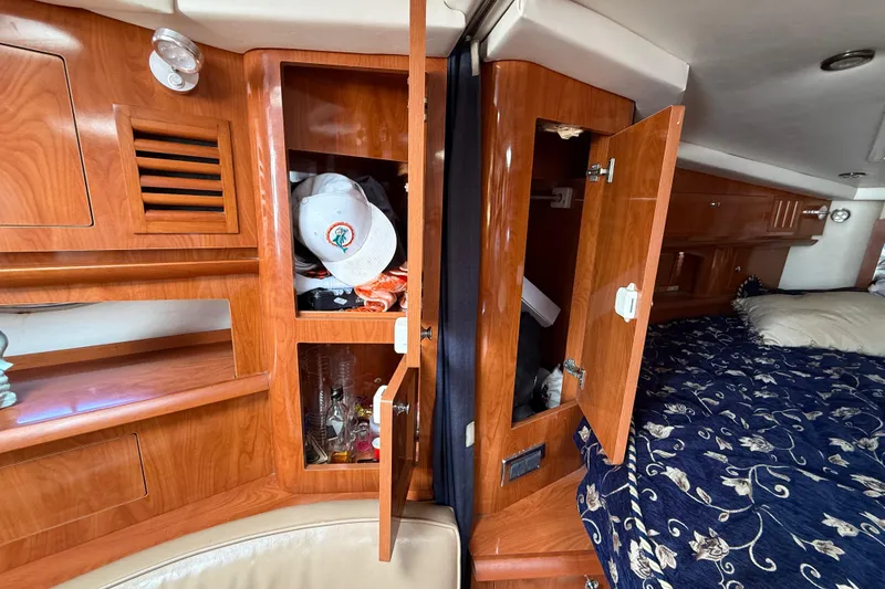 Slide: The Image of Interior of 2005 Four Winns 348 Vista boat with wooden cabinets and bed. - 56