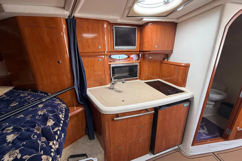 Slide: The Image of 2005 Four Winns 348 Vista yacht interior with kitchenette and wood cabinetry. - 57
