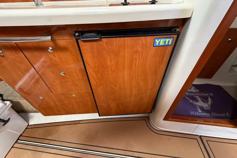Slide: The Image of 2005 Four Winns 348 Vista interior with wood cabinetry and Yeti-branded mini fridge. - 61