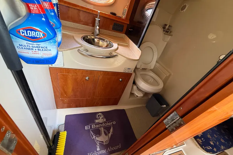 Slide: The Image of Compact bathroom in 2005 Four Winns 348 Vista boat with cleaning supplies. - 63