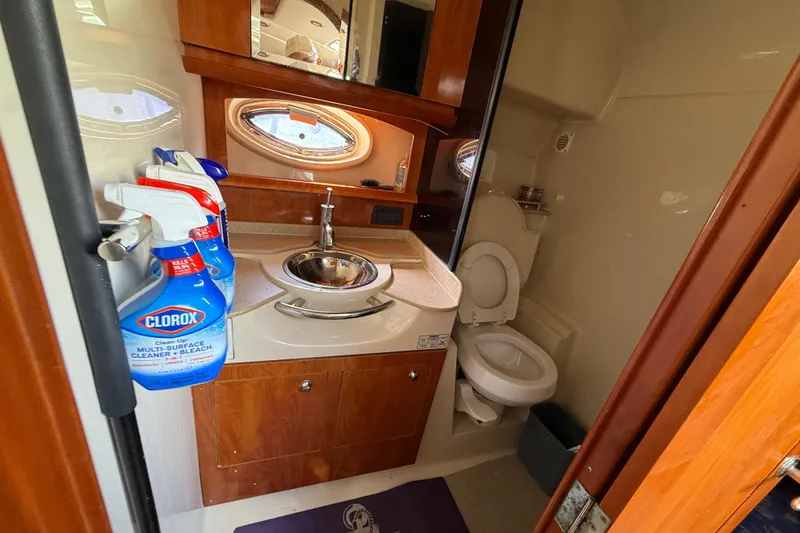 Slide: The Image of 2005 Four Winns 348 Vista yacht bathroom with sink, toilet, and cleaning supplies. - 64