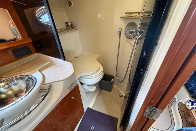 Slide: The Image of 2005 Four Winns 348 Vista boat bathroom with shower, sink, and toilet. - 66