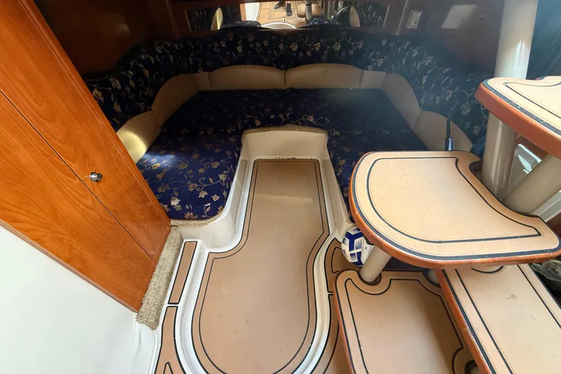Slide: The Image of 2005 Four Winns 348 Vista cabin interior with seating and wooden accents. - 70