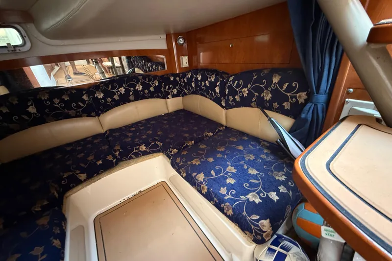 Slide: The Image of 2005 Four Winns 348 Vista cabin interior with floral upholstery and wooden accents. - 73