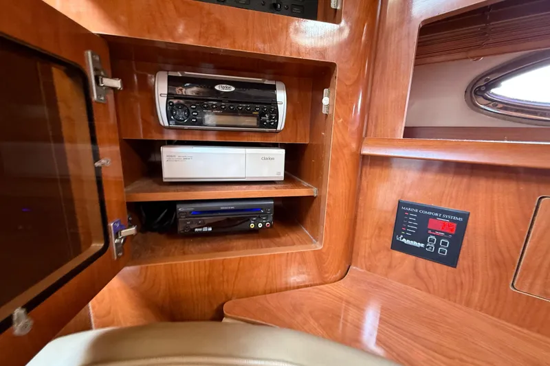 Slide: The Image of 2005 Four Winns 348 Vista cabin with audio system and marine comfort controls. - 75
