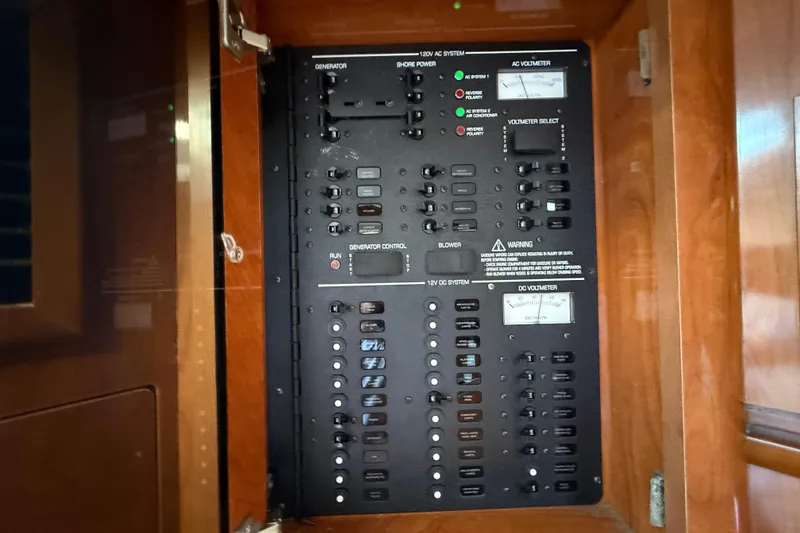 Slide: The Image of Electrical control panel inside a 2005 Four Winns 348 Vista boat. - 76