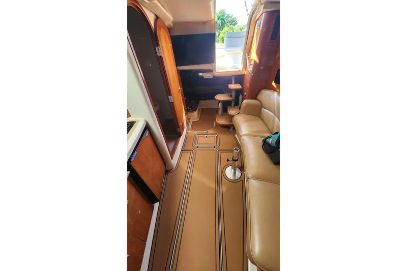 Slide: The Image of 2005 Four Winns 348 Vista boat docked in a marina under a clear blue sky. - 8