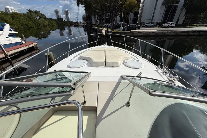 Slide: The Image of 2005 Four Winns 348 Vista yacht docked by a serene canal with cityscape views. - 80