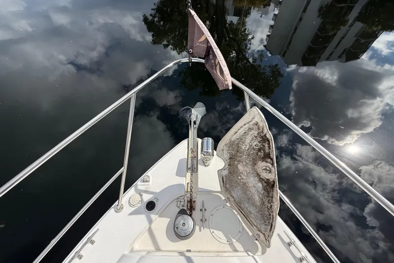 Slide: The Image of Bow view of 2005 Four Winns 348 Vista boat reflecting sky and clouds. - 83