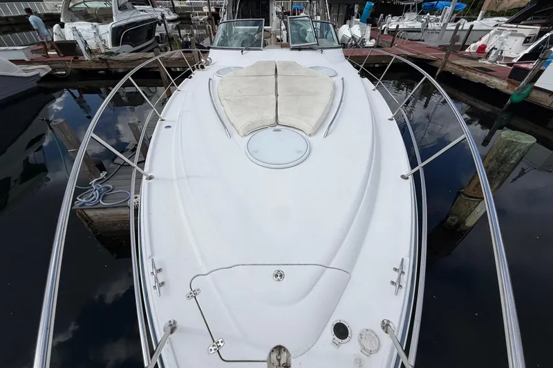 Slide: The Image of 2005 Four Winns 348 Vista boat docked, showcasing spacious deck and sleek design. - 86