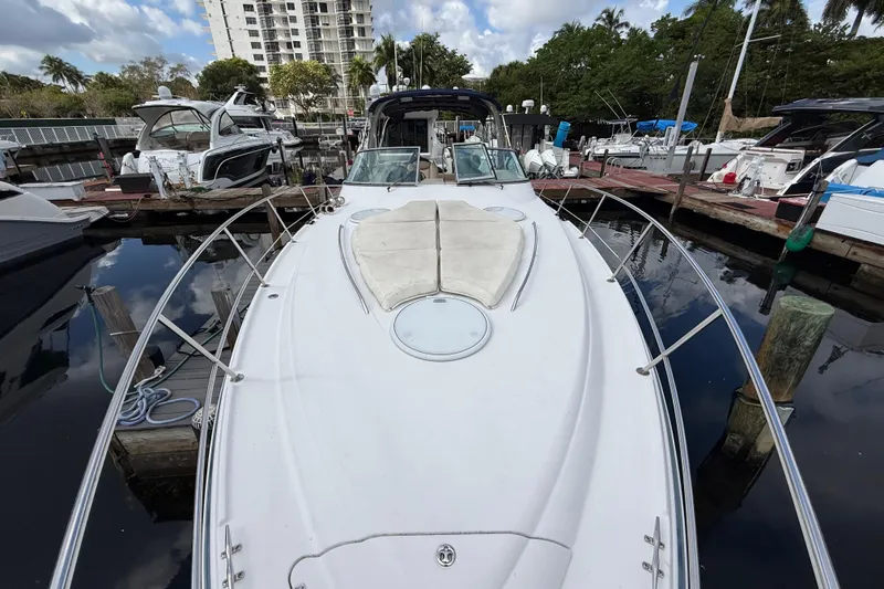 Slide: The Image of 2005 Four Winns 348 Vista yacht docked at marina, surrounded by other boats. - 87