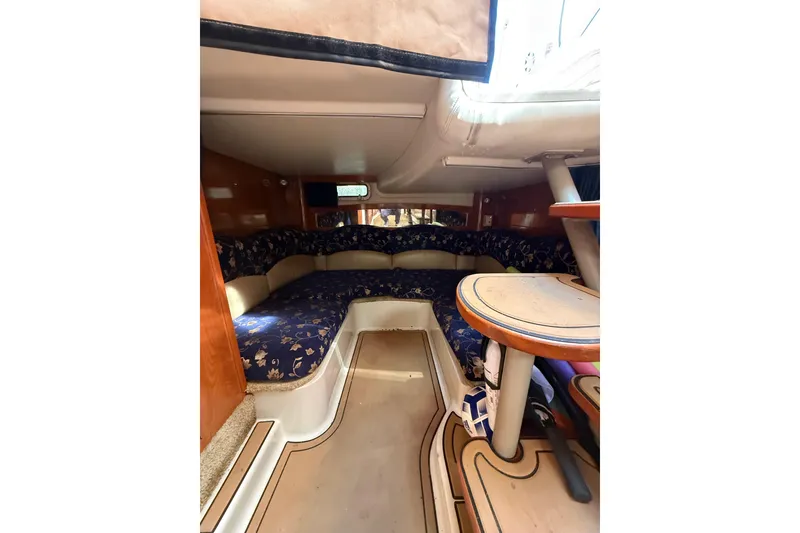 Slide: The Image of 2005 Four Winns 348 Vista yacht docked at marina with cityscape background. - 9