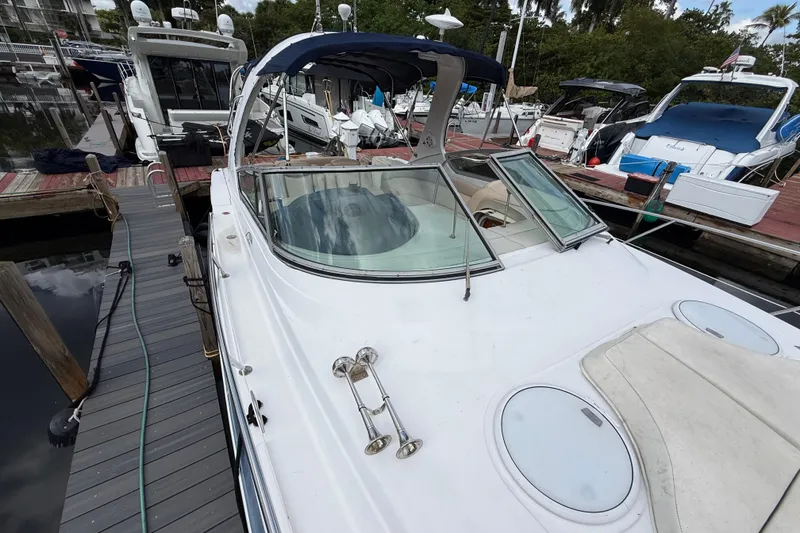 Slide: The Image of 2005 Four Winns 348 Vista yacht docked at marina, featuring sleek design and spacious deck. - 92