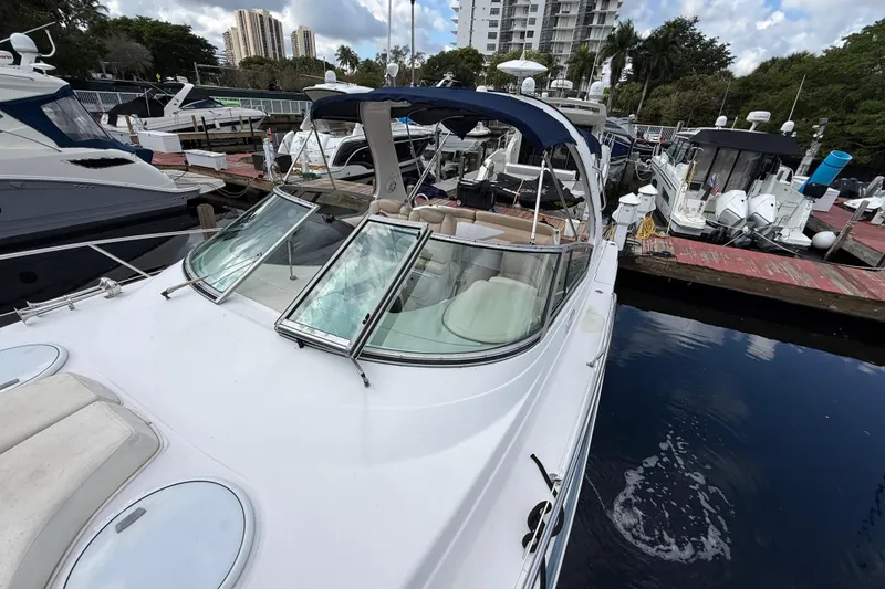 Slide: The Image of 2005 Four Winns 348 Vista yacht docked at marina, surrounded by other boats. - 93