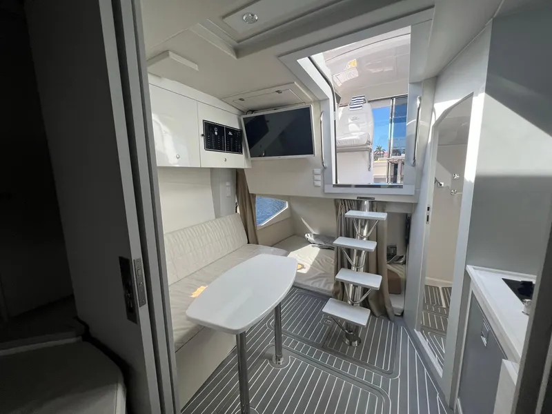 Slide: The Image of Compact kitchen area in a 2021 Evolve 400HT boat, featuring modern appliances and sleek design. - 14