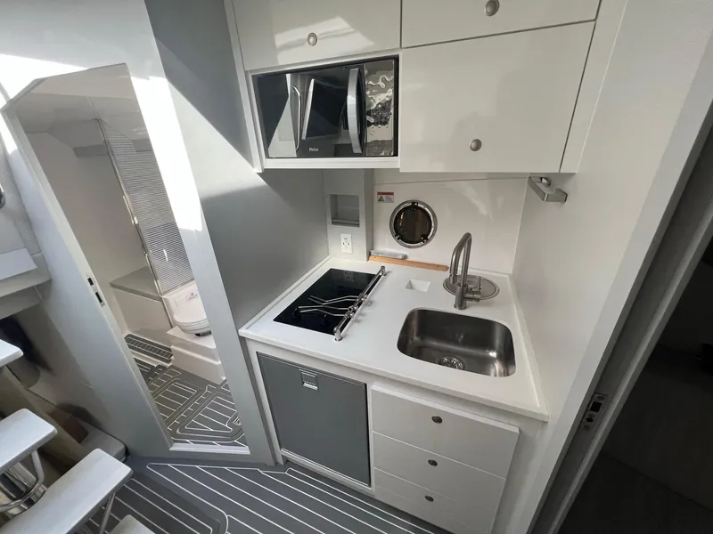 Slide: The Image of Interior of 2021 Evolve 400HT boat with kitchenette and seating area. - 16