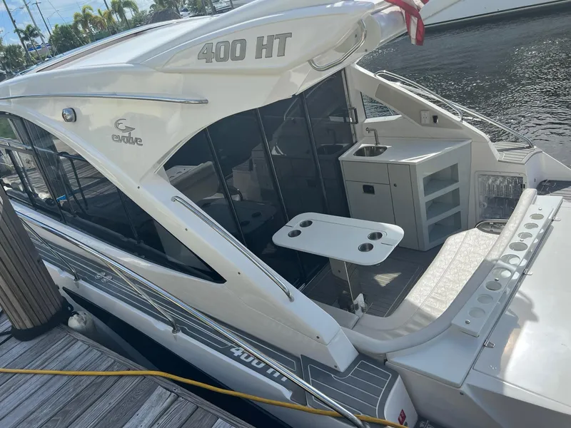 Slide: The Image of 2021 Evolve 400HT boat interior with white seating and sleek table design. - 19