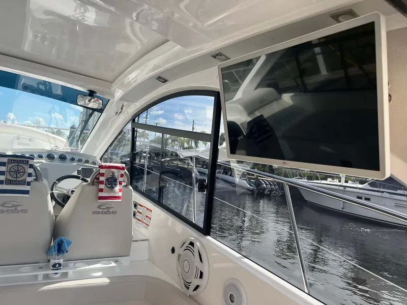 Slide: The Image of 2021 Evolve 400HT boat with gray cover docked at marina. - 22