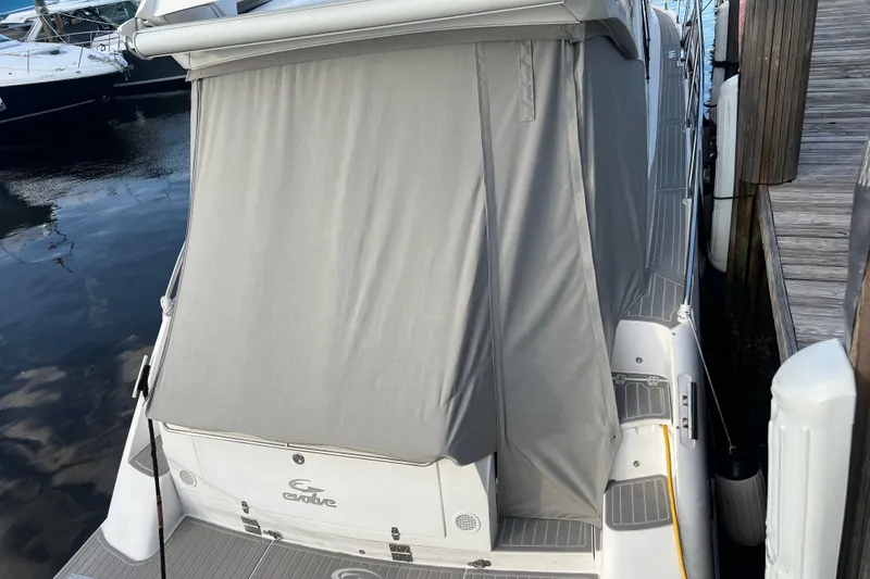 Slide: The Image of Interior of 2021 Evolve 400HT boat with modern dashboard and palm trees outside. - 24