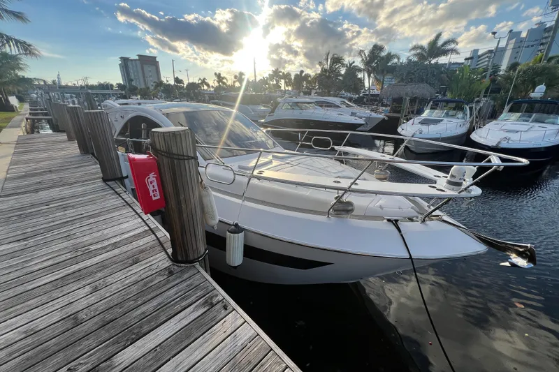 Slide: The Image of Evolve 400HT 2021 yacht docked at marina with surrounding boats and palm trees. - 26