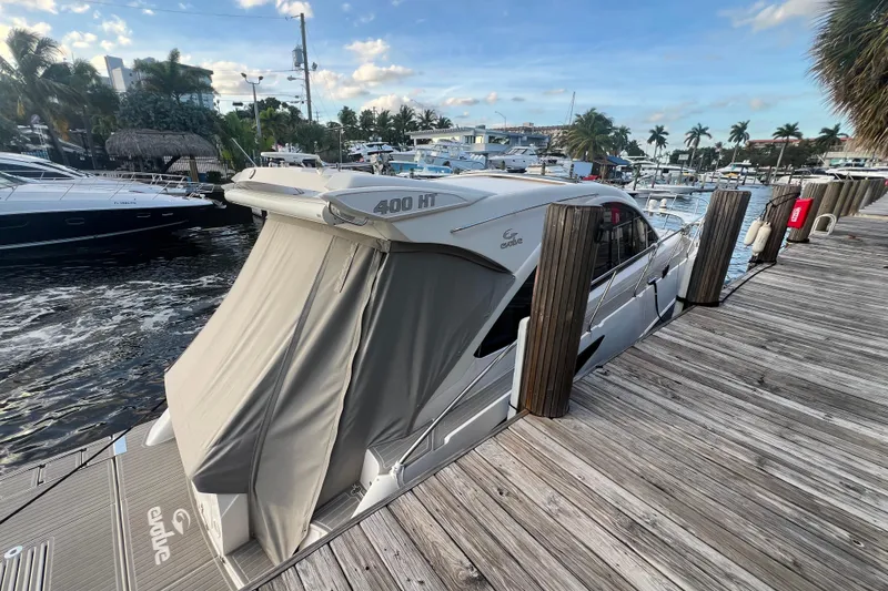 Slide: The Image of 2021 Evolve 400HT boat stern with sleek gray deck and logo. - 28