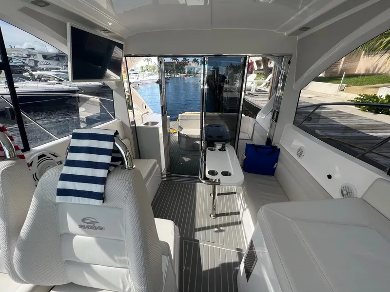Slide: The Image of Interior of 2021 Evolve 400HT boat with modern seating and storage cabinets. - 6