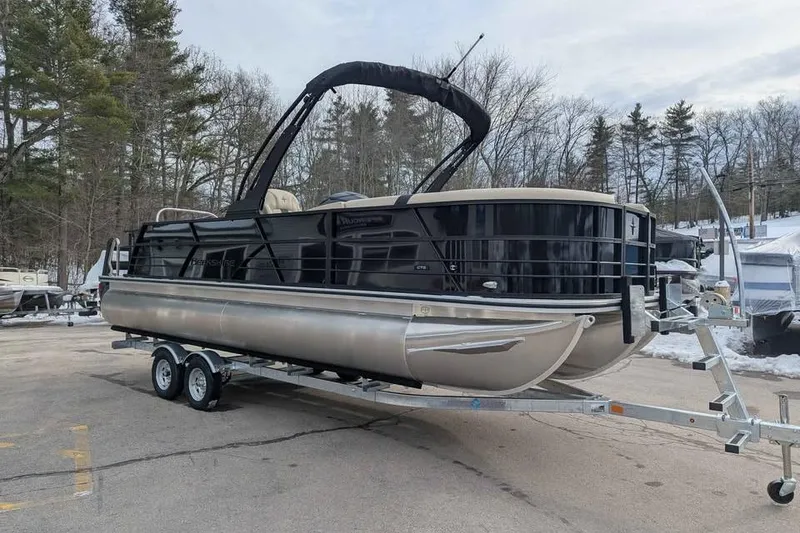 Slide: The Image of 2026 Berkshire 24UL CTS pontoon boat on trailer in snowy outdoor setting. - 0