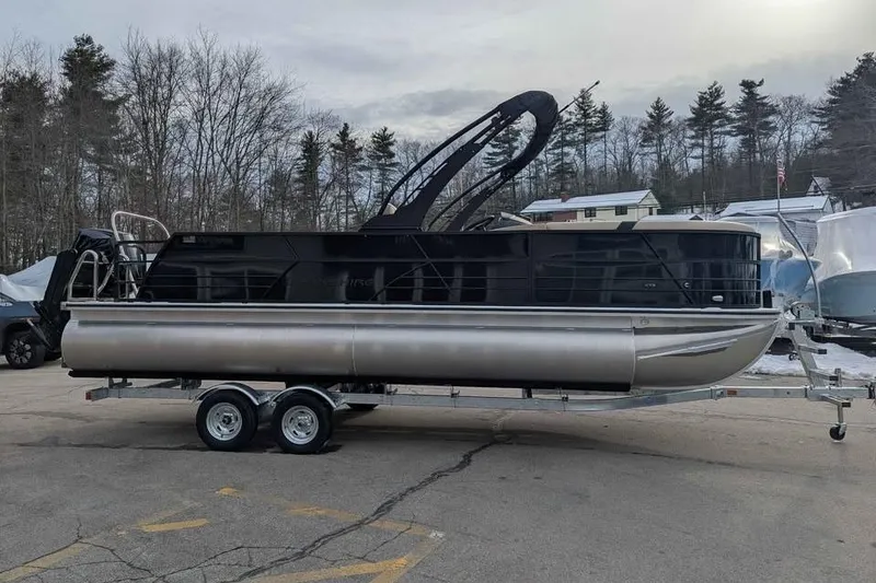 Slide: The Image of 2026 Berkshire 24UL CTS pontoon boat on trailer, parked outdoors. - 1