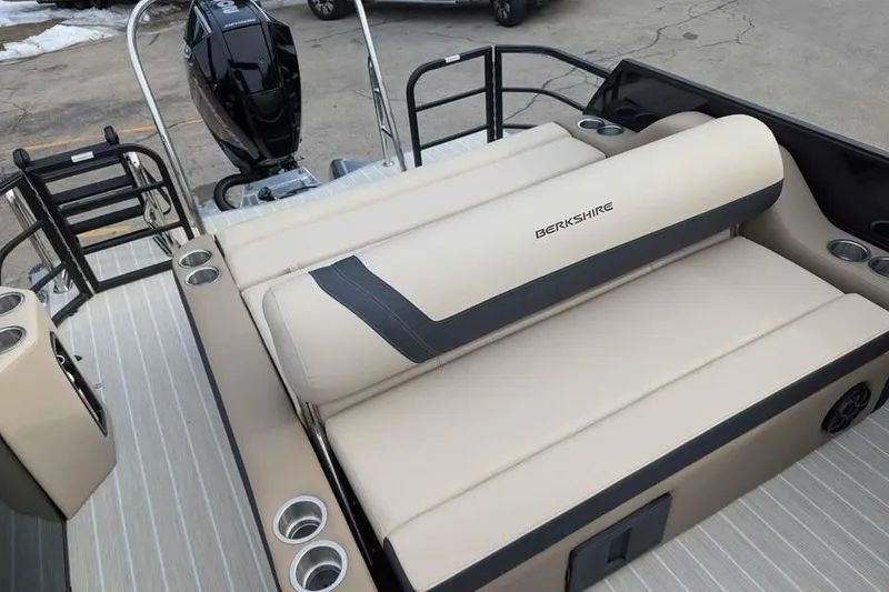 Slide: The Image of 2026 Berkshire 24UL CTS boat with beige seating and outboard motor. - 10