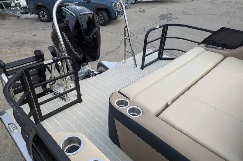 Slide: The Image of 2026 Berkshire 24UL CTS pontoon boat with Mercury outboard engine, beige seating, and cup holders. - 11
