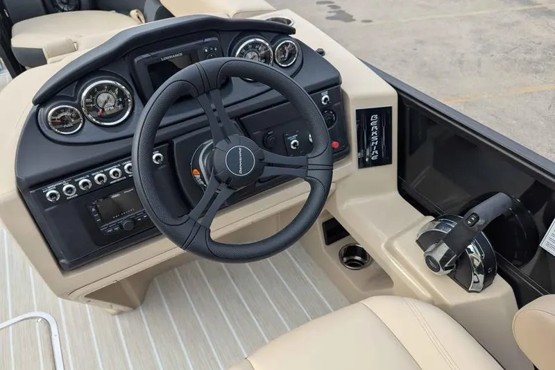 Slide: The Image of 2026 Berkshire 24UL CTS boat dashboard with steering wheel and control panel. - 12