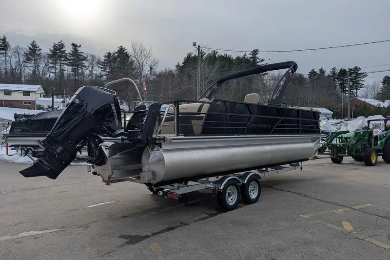 Slide: The Image of 2026 Berkshire 24UL CTS pontoon boat on trailer, parked outdoors in winter setting. - 2