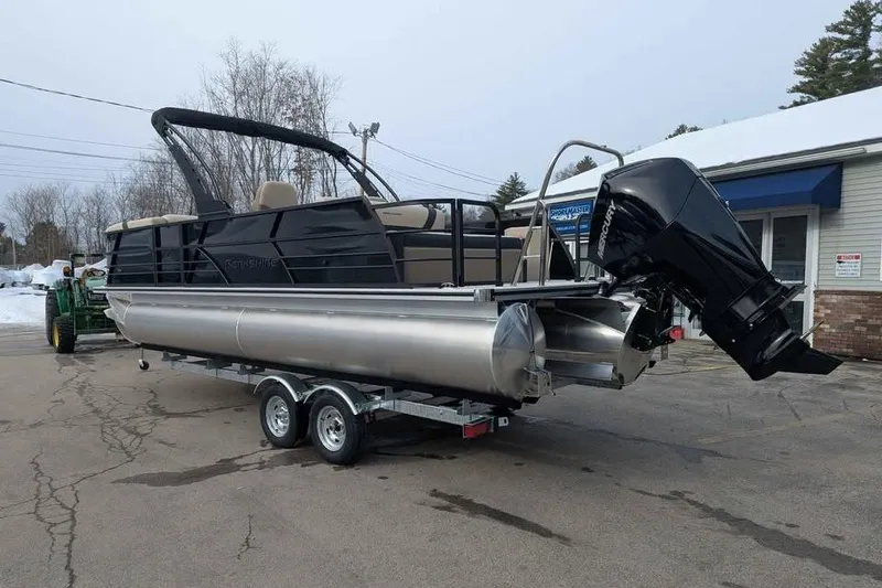 Slide: The Image of 2026 Berkshire 24UL CTS pontoon boat on trailer with outboard motor in parking lot. - 4