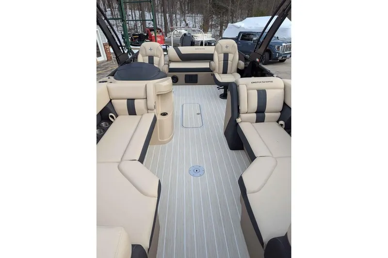 Slide: The Image of 2026 Berkshire 24UL CTS pontoon boat interior with beige seating and striped flooring. - 7